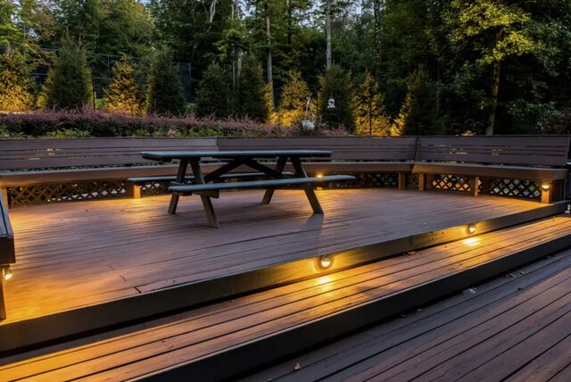 Composite deck with step and rail lighting at dusk